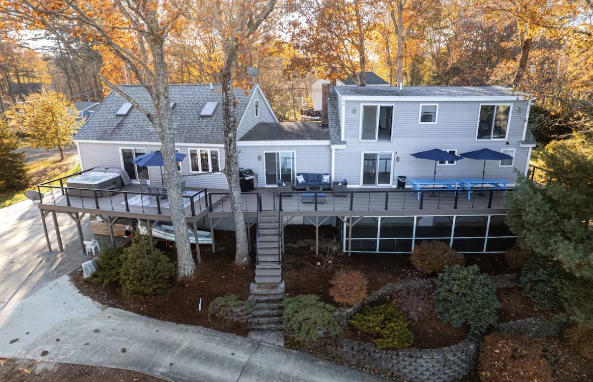 Aerial view of the lake house deck surrounded by autumn trees